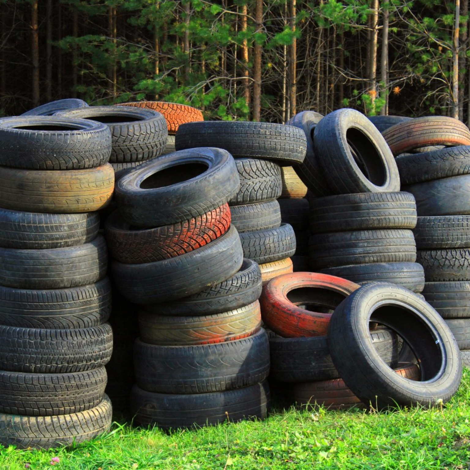 pile-old-car-tires-lies-grass-against-background-forest-ecology-concept
