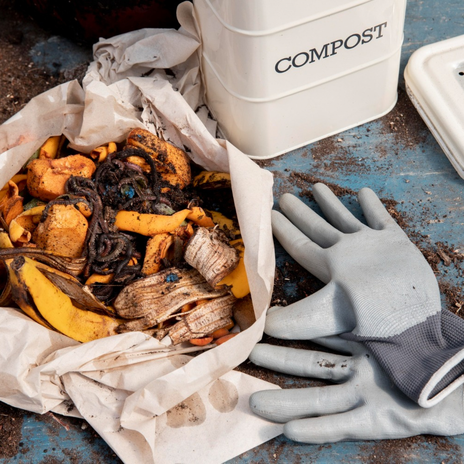 food waste on a paper with with gardening gloves to be used in upcycling food waste
