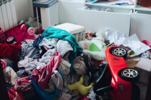 messy room with cluttered dress and toys not being prevented to be cluttered at home