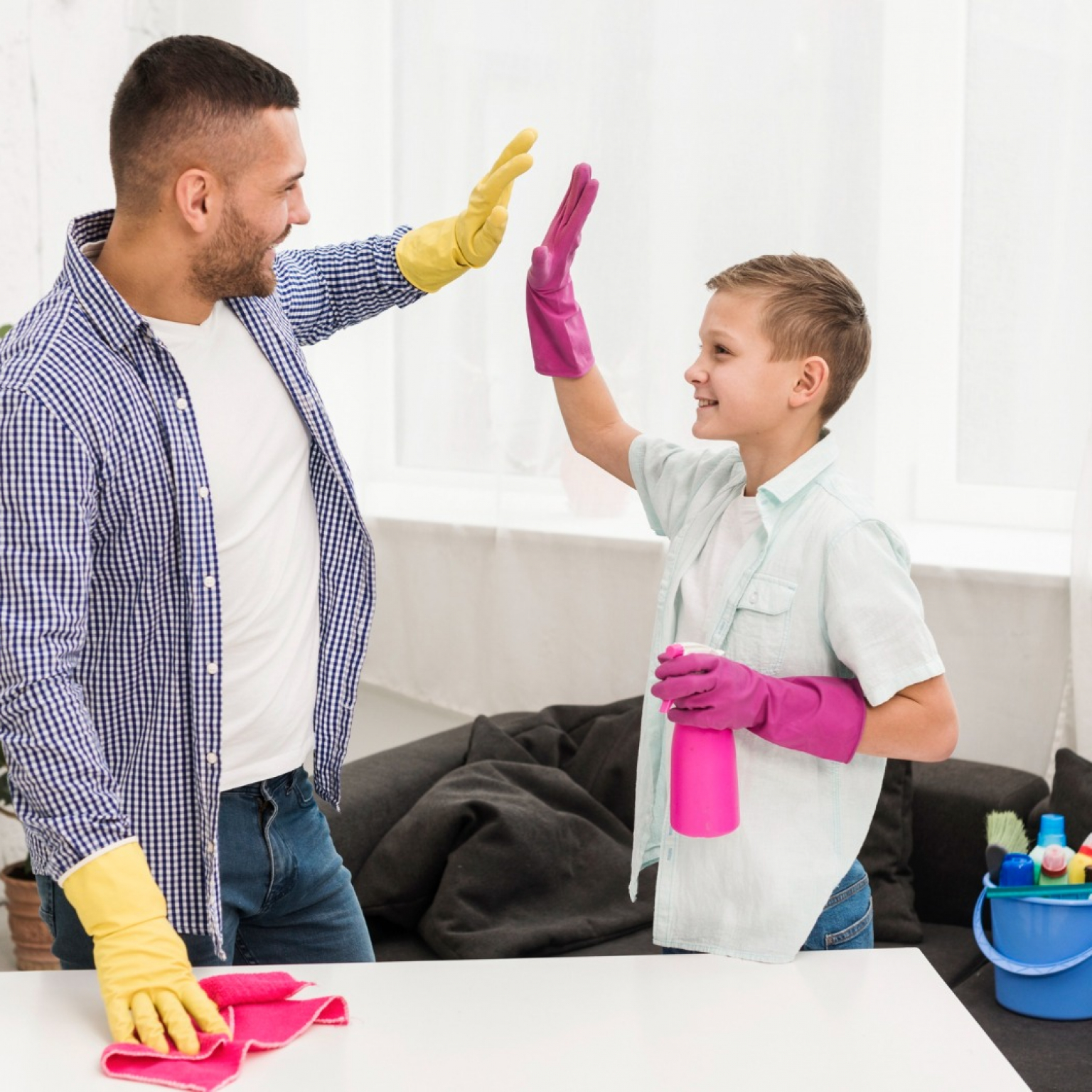 happy father and son high five each other after involving his child in a junk removal process