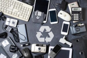 old electronic devices on a dark background with a concept of recycling for a better disposal of electronic waste