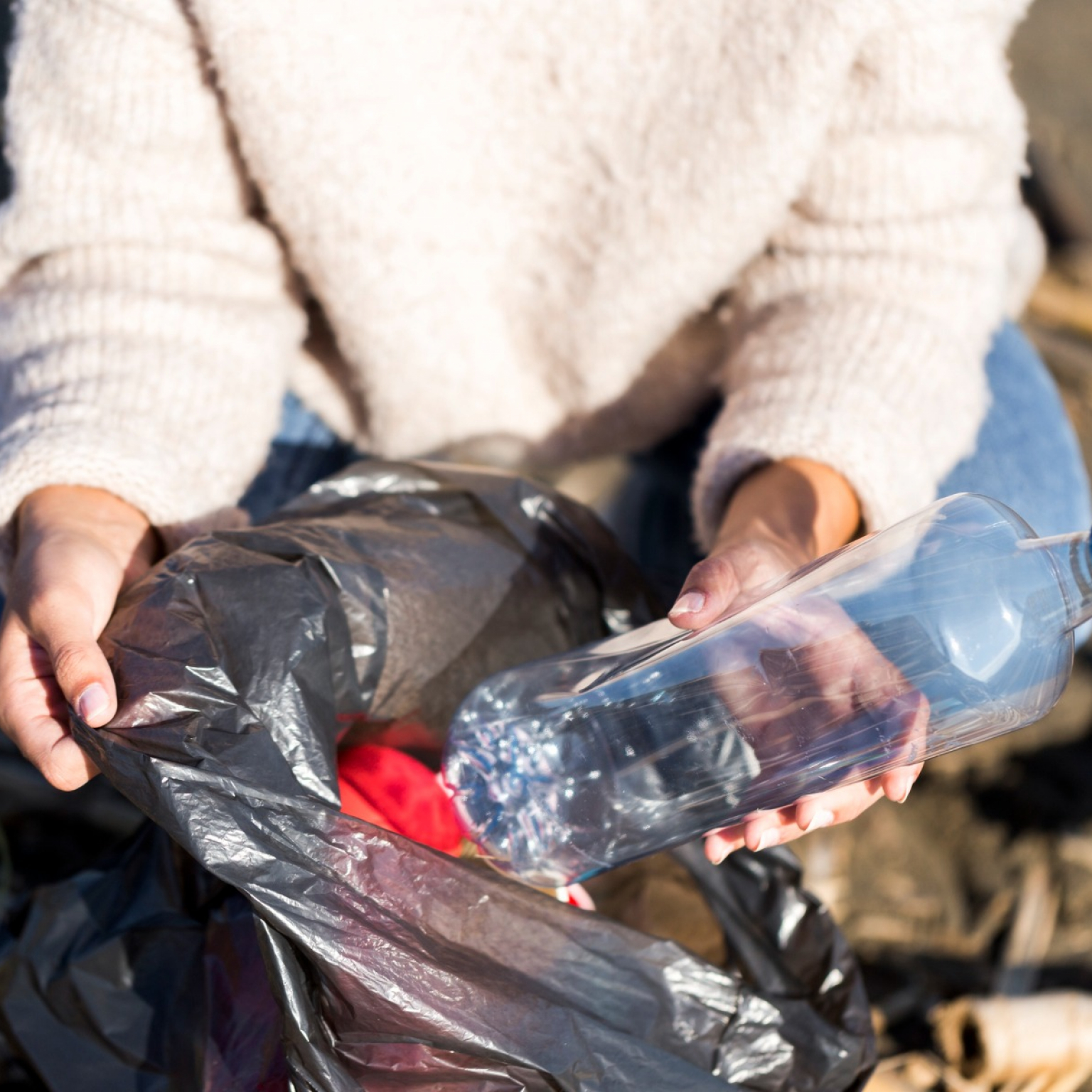 woman-picking-trash-from-seaside
