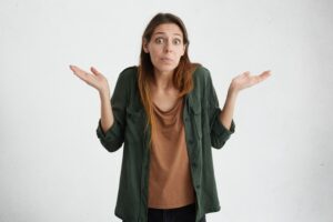 clueless-puzzled-woman-with-widely-opened-eyes-having-hesitation-shrugging-her-shoulders-expressing-uncertainty-nobody-cares-about-it