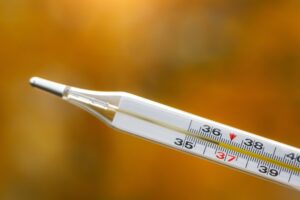 a mercury thermometer on an autumn background ready for safety disposal