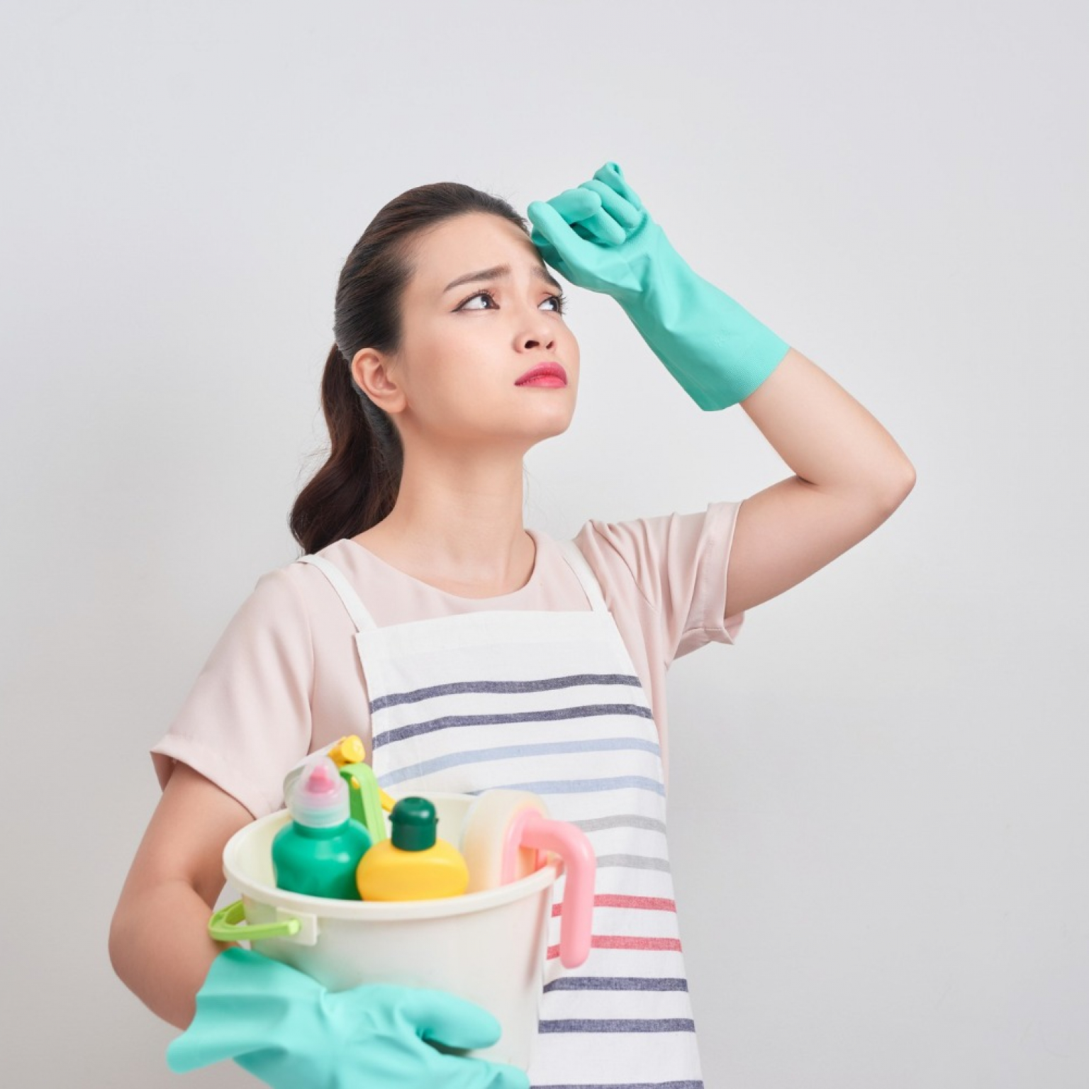 young housewife is tired cleaning thinking on how to get the most out of a rental garbage bin