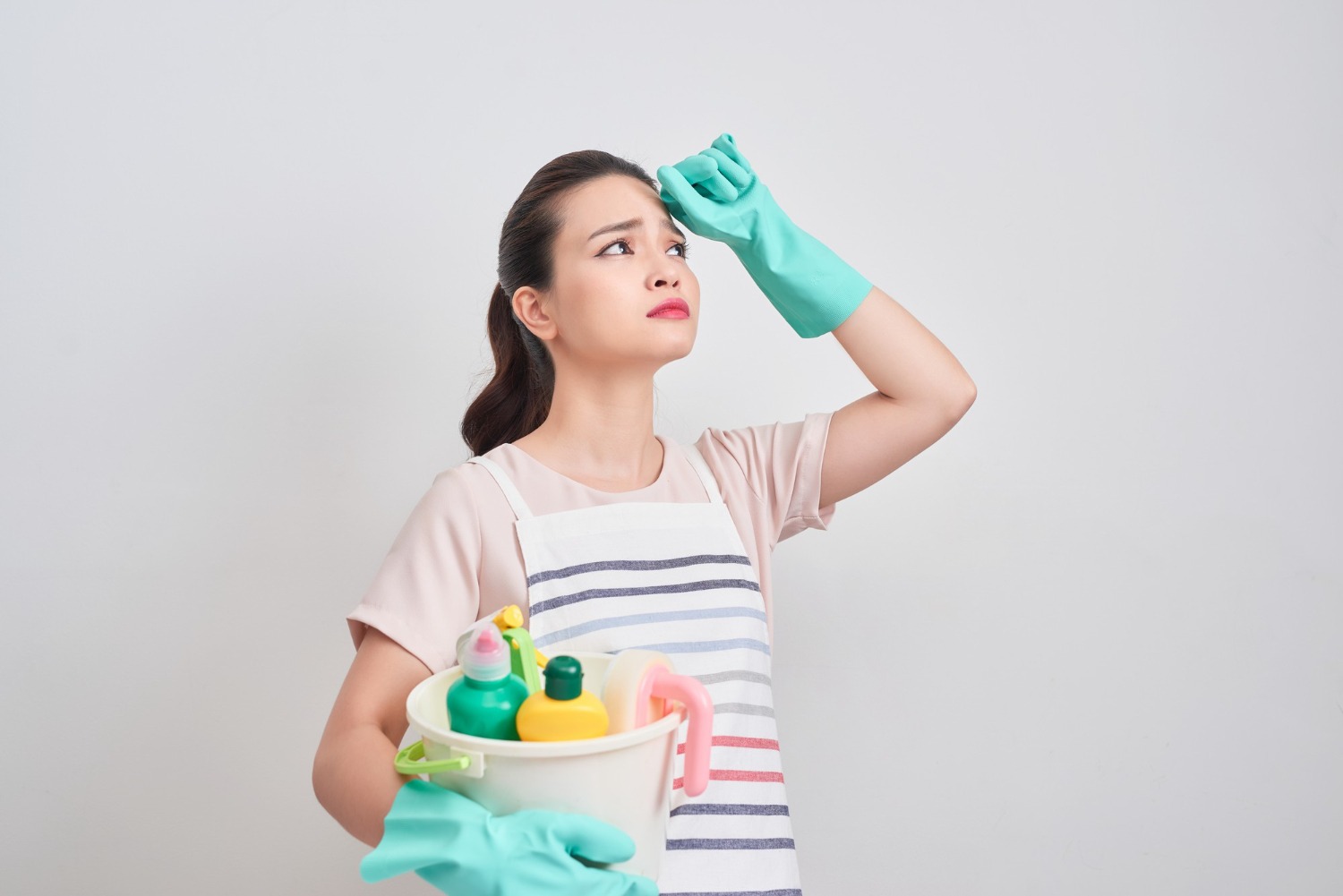young housewife is tired cleaning thinking on how to get the most out of a rental garbage bin