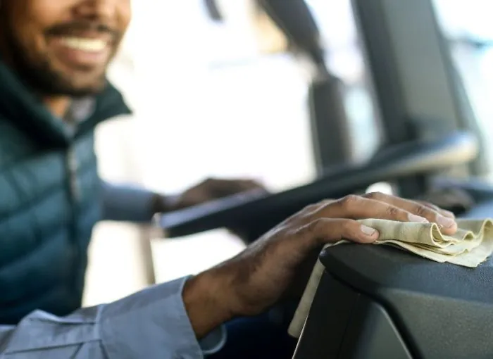 happy Junk It employee cleaning the truck and ready to deliver garbage bin to client in Brampton