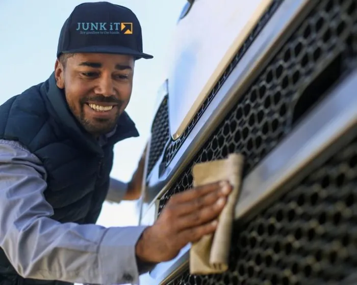A Junk It employee cleaning the truck - ensuring top-notch service for your garbage bin rental in Vancouver