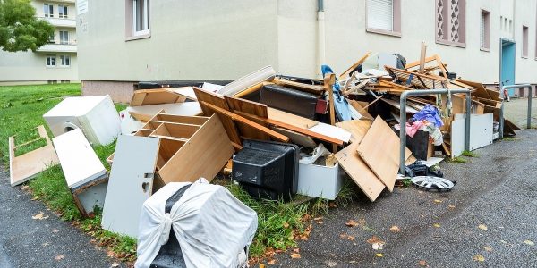 Residential garbage outside a house, in need of a stress-free dumpster rental in Canada