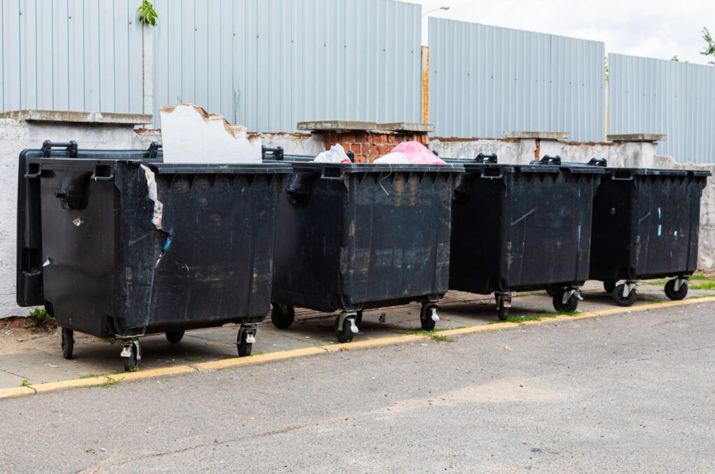 Junk It black garbage containers on the street to Choose the Perfect Disposal Bin