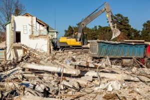excavator-loads- remains-destroyed-building-junk-it-dumpster-truck