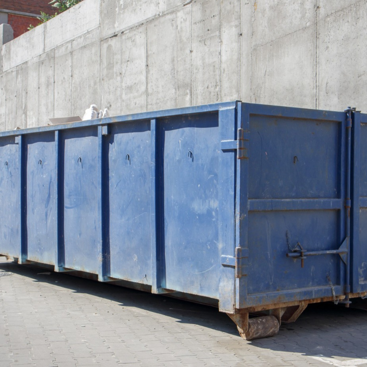 metal-durable,-blue-large-Junk-It- industrial-dumpster bin-inside-industrial-area-tips-when-working-with-dumper-rental