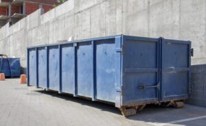 metal-durable,-blue-large-Junk-It- industrial-dumpster bin-inside-industrial-area-tips-when-working-with-dumper-rental