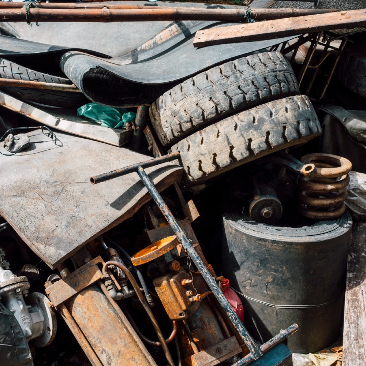 old rusty junks of steels and rubbers put in rented Junk It dumpster bin