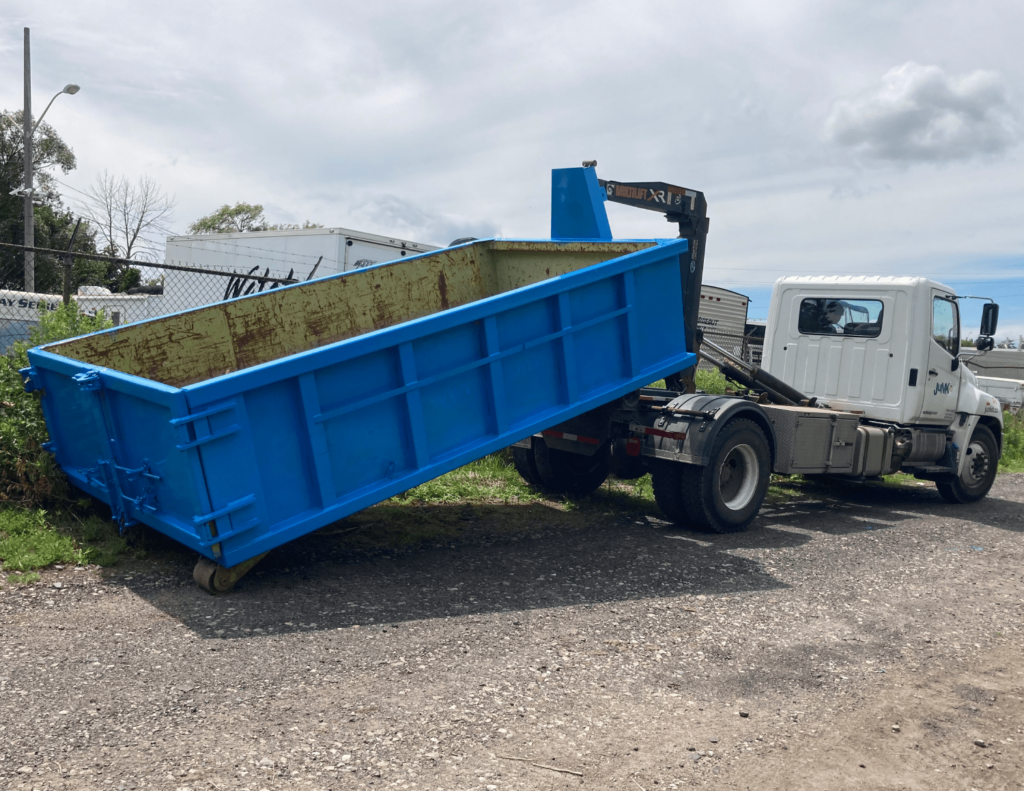 white truck delivering a rented junk it garbage bin in Canada - learn more other FAQs of renting garbage bins
