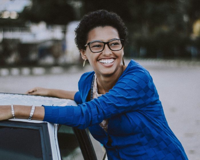 a black woman weaing blue shirt enjoying hassle-free waste management using Junk It's garbage bin rental in Mississauga