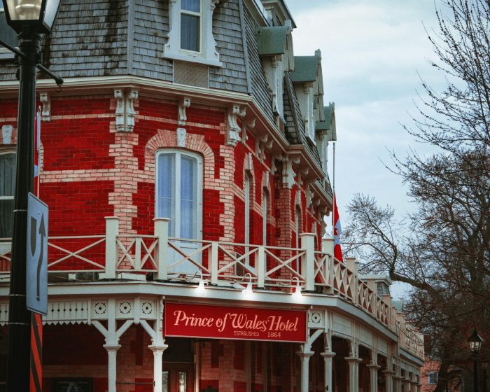 Facade of the Prince of Wales Hotel - with a backdrop of stunning landscapes, symbolizing luxury and comfort - much like the convenience of garbage dumpster rental services in Niagara for a hassle-free clean-up