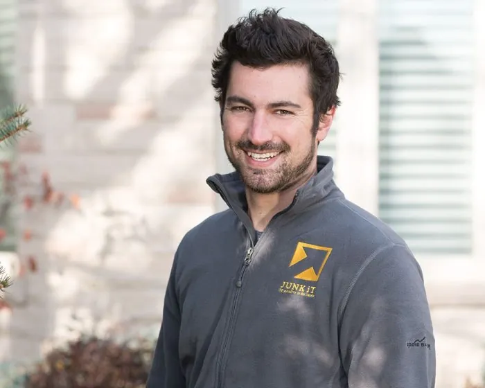 junk it employee smiling - be happy too if you choose junk it garbage/dumpster rental services in Ontario