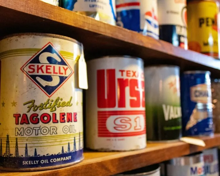a wooden shelf lined with paint cans - sample items of what not to throw on junk it garbage bins - What Not to Throw in Your Bin Rental in Cambridge