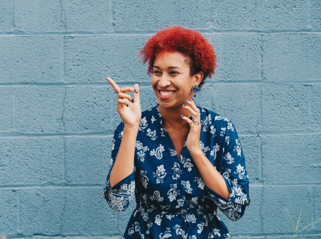 a woman smilling and pointing - be happy and satisfied just like junk it's clients who choosed junk it's residentail dumpster rental services in Canada - learn more about approved junk/trash for residential garbage bins