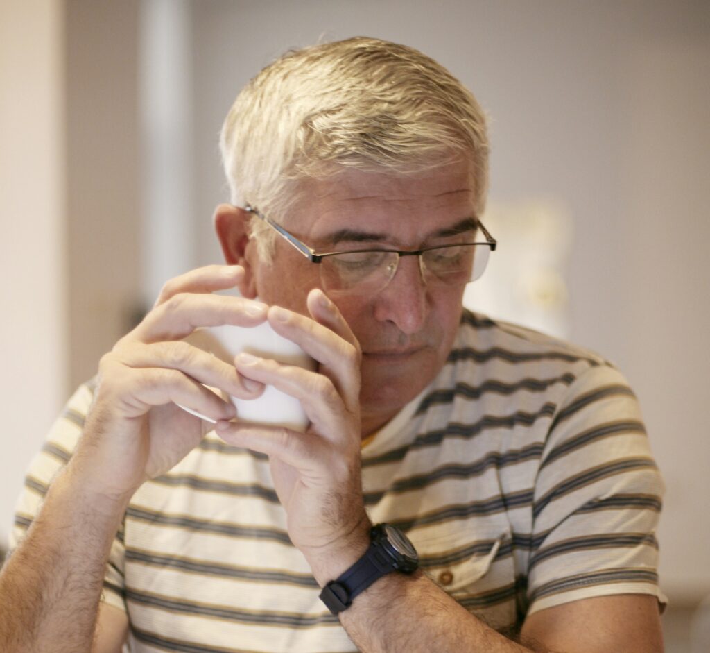 Man thinking while looking down, considering how garbage bin rental in Toronto can help manage waste more effectively