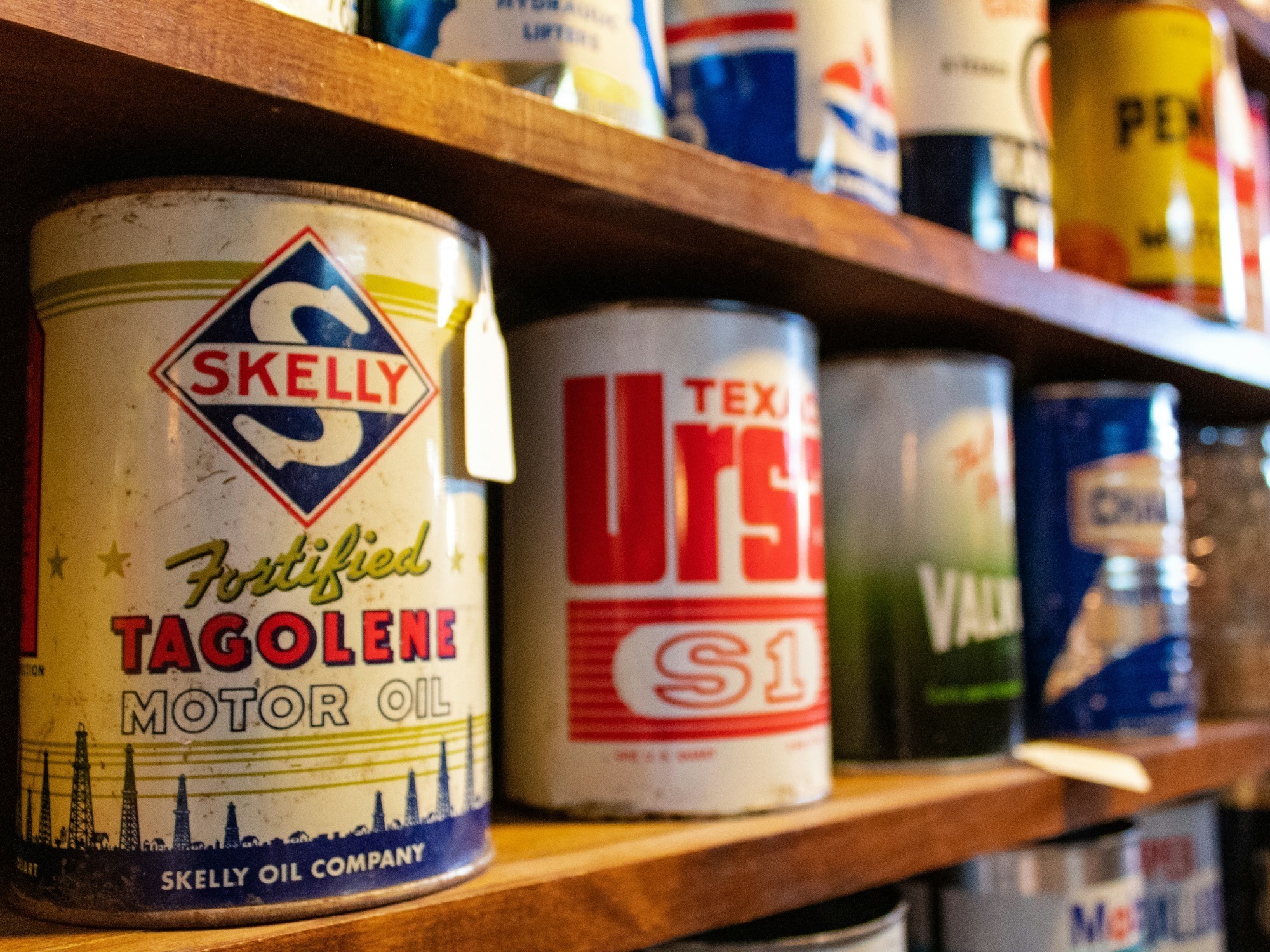 a wooden shelf lined with paint cans - sample items of what not to throw on junk it garbage bins - What Not to Throw in Your Bin Rental in Burlington