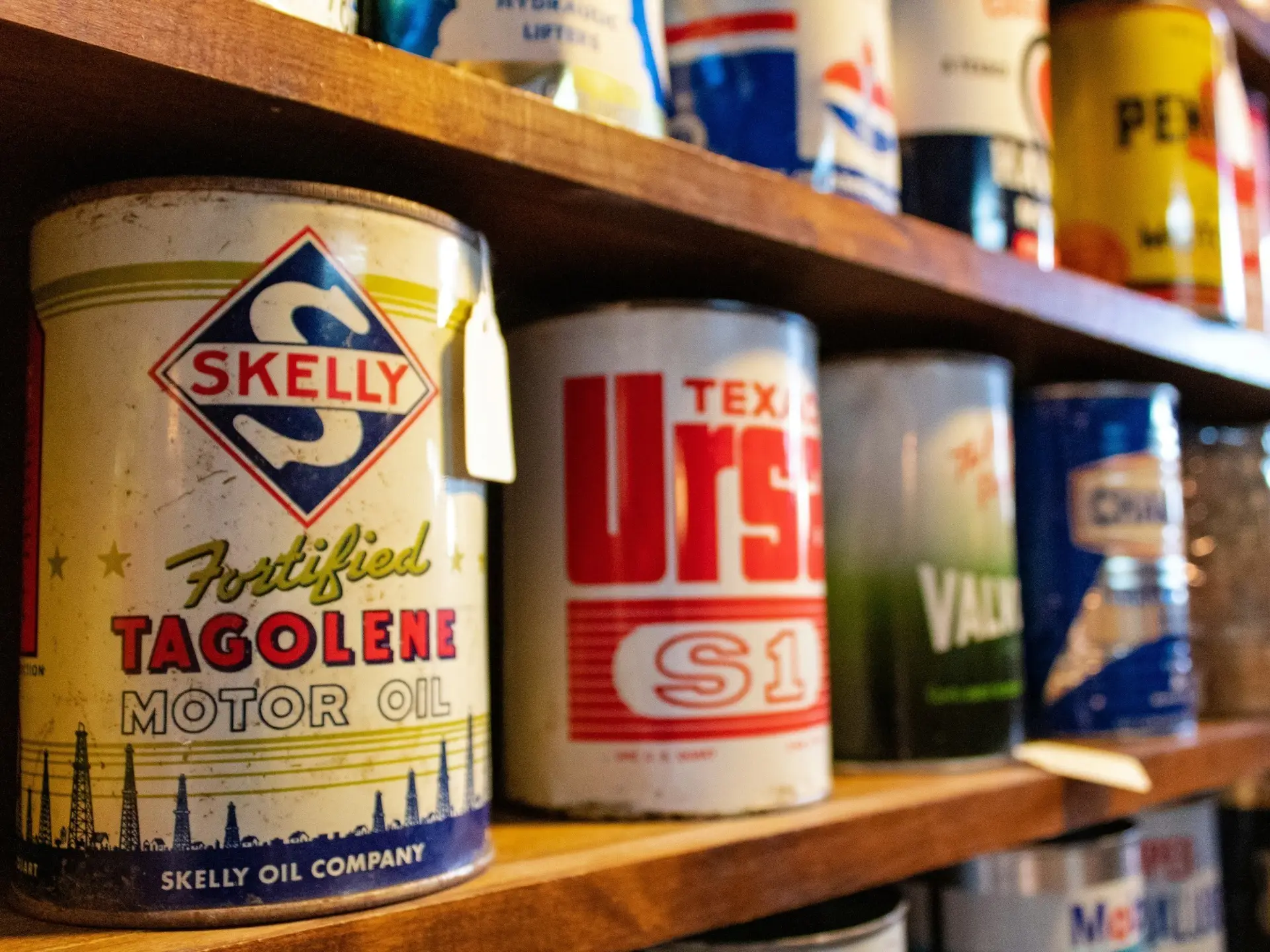 a wooden shelf lined with paint cans - sample items of what not to throw on junk it garbage bins - What Not to Throw in Your Bin Rental in Kitchener