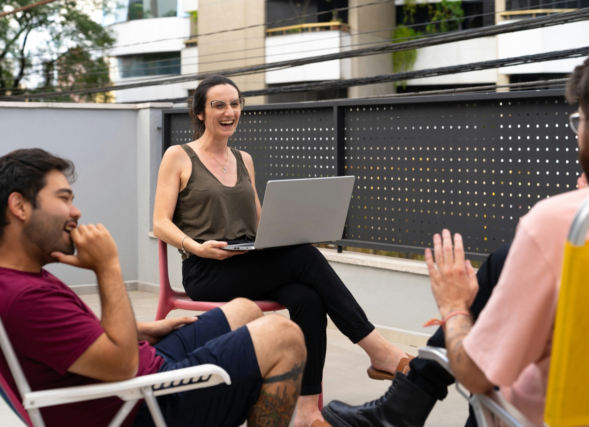 woman with a laptop chatting with her friends - if you’re managing a business, explore commercial bin rental services in Burlington for easy waste disposal