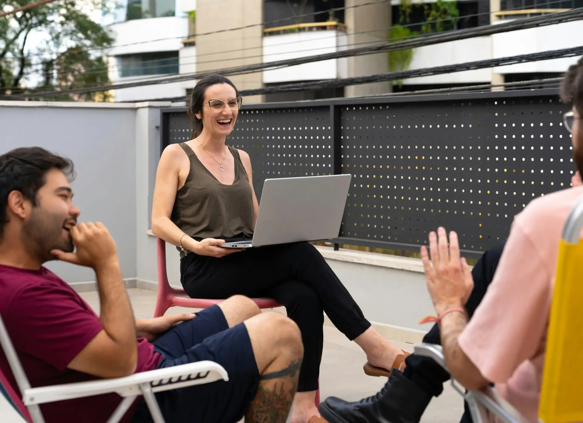 A woman with a laptop chatting with her friends, while considering how easy it could be to clear out clutter with reliable bin rental in Kitchener