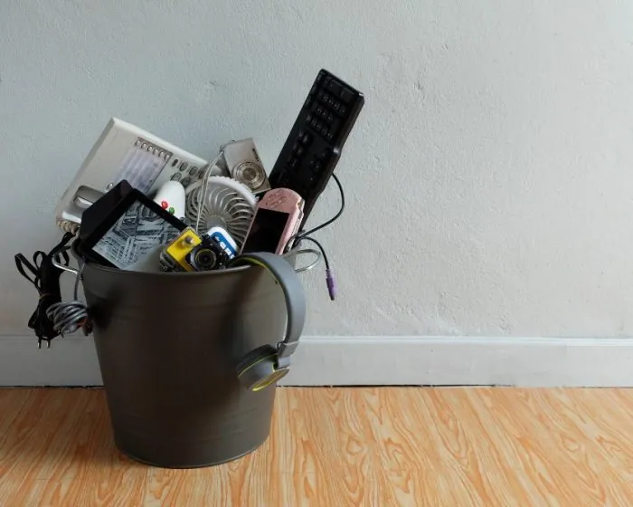a bucket filled with broken gadgets and other electronic waste - perfect for disposal with garbage bin rental in North York to keep your space clutter-free