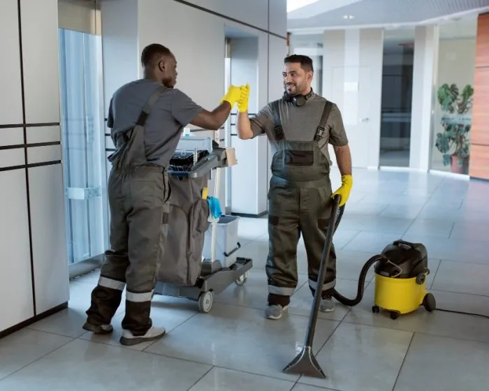 Two people sitting on individual rocking chairs by a porch - enjoying their time while considering hassle-free garbage bin rental in Scarborough for their waste disposal needs